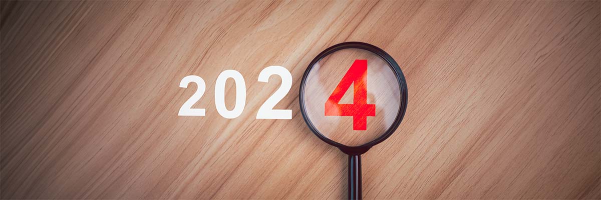 loupe sur 2024 qui symbolise les changements qui concerneront les entreprises en 2024 qu'il faut étudier
